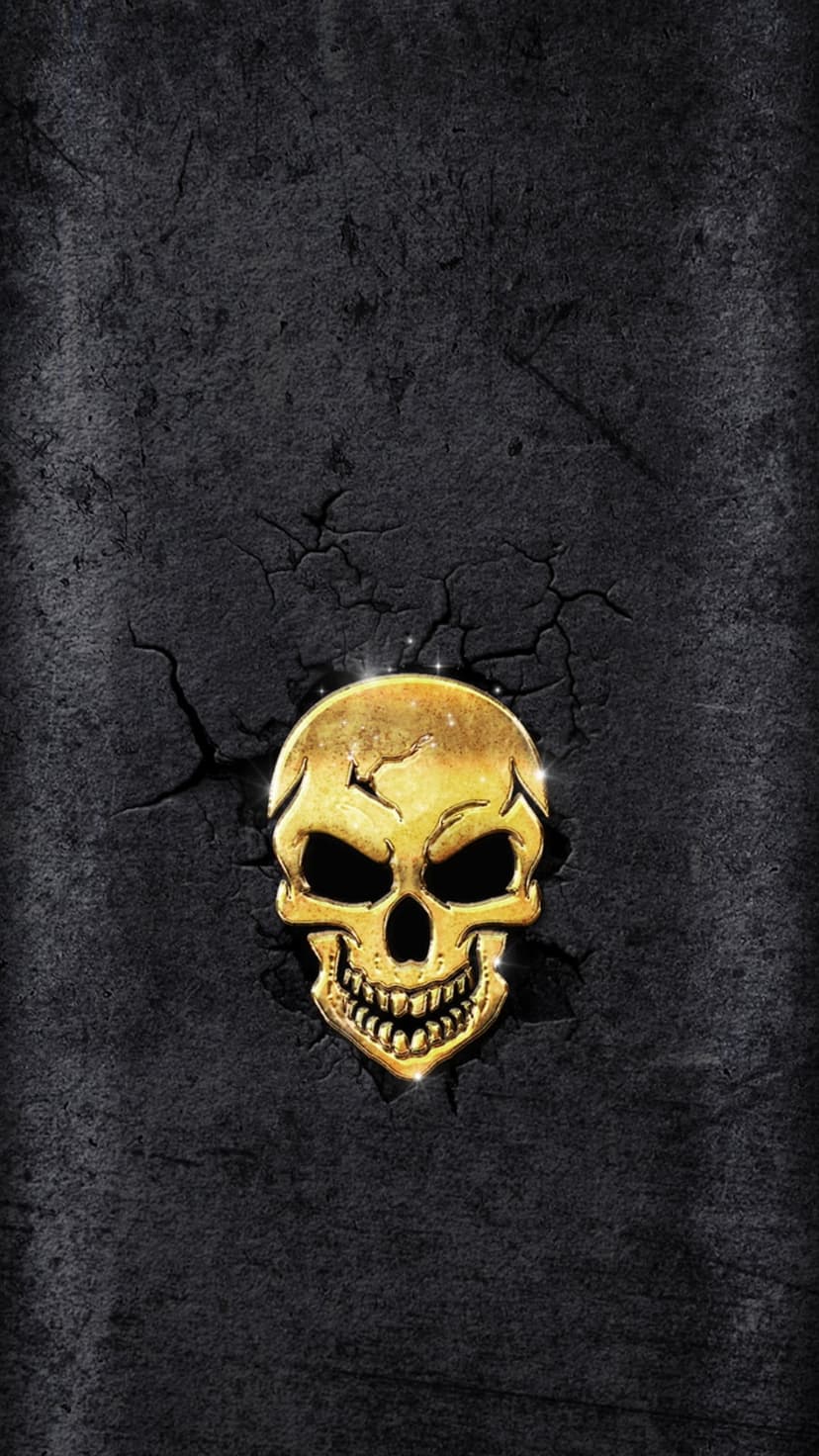 Golden human skull with reflective surfaces resting on a black background featuring deep geometric cracks.