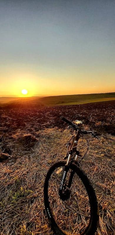 Mountain bike at sunset in a plowed field