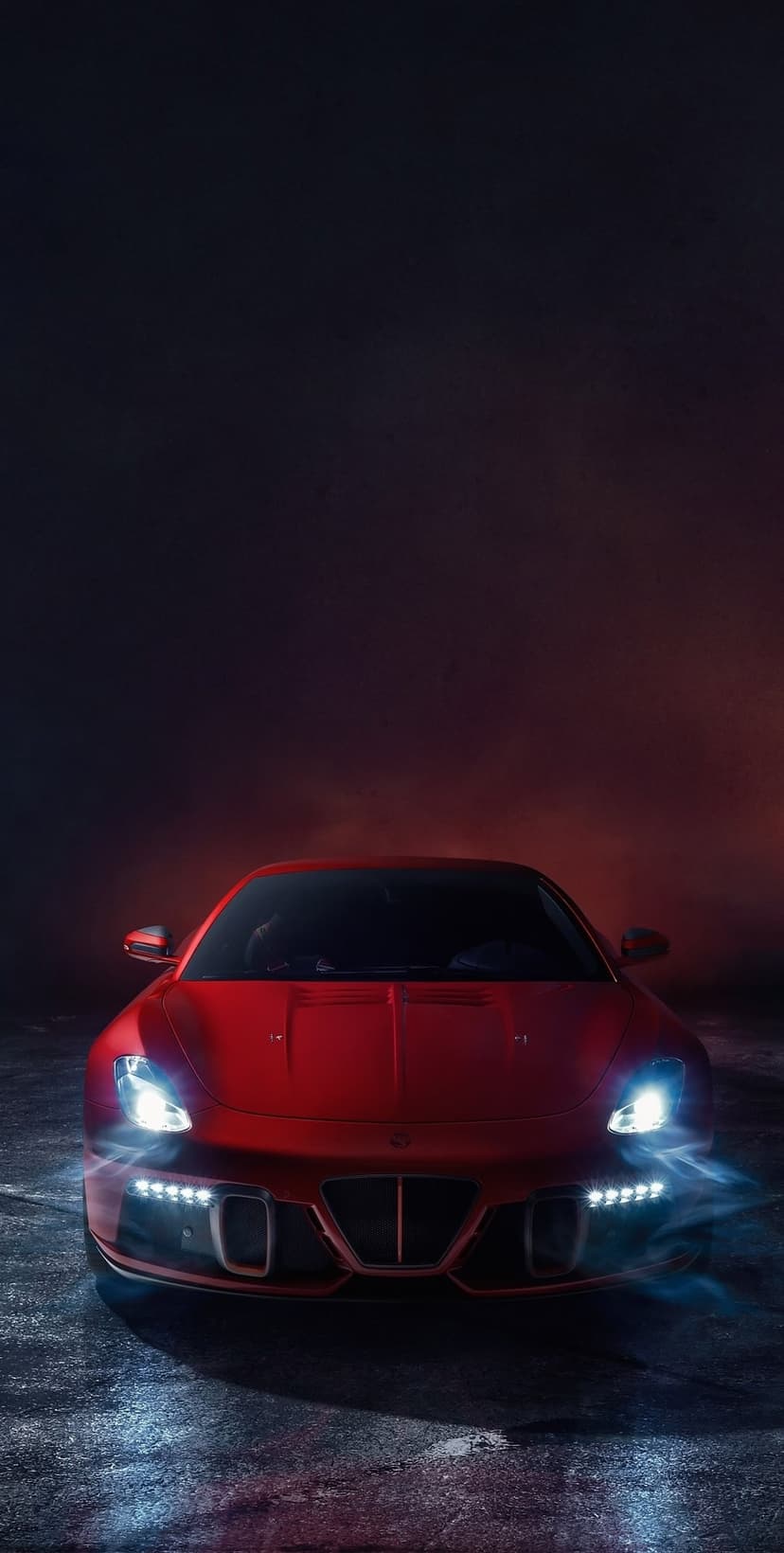 Red sports car headlights glow on wet asphalt with mist and dramatic blue and red ambient lighting at night.