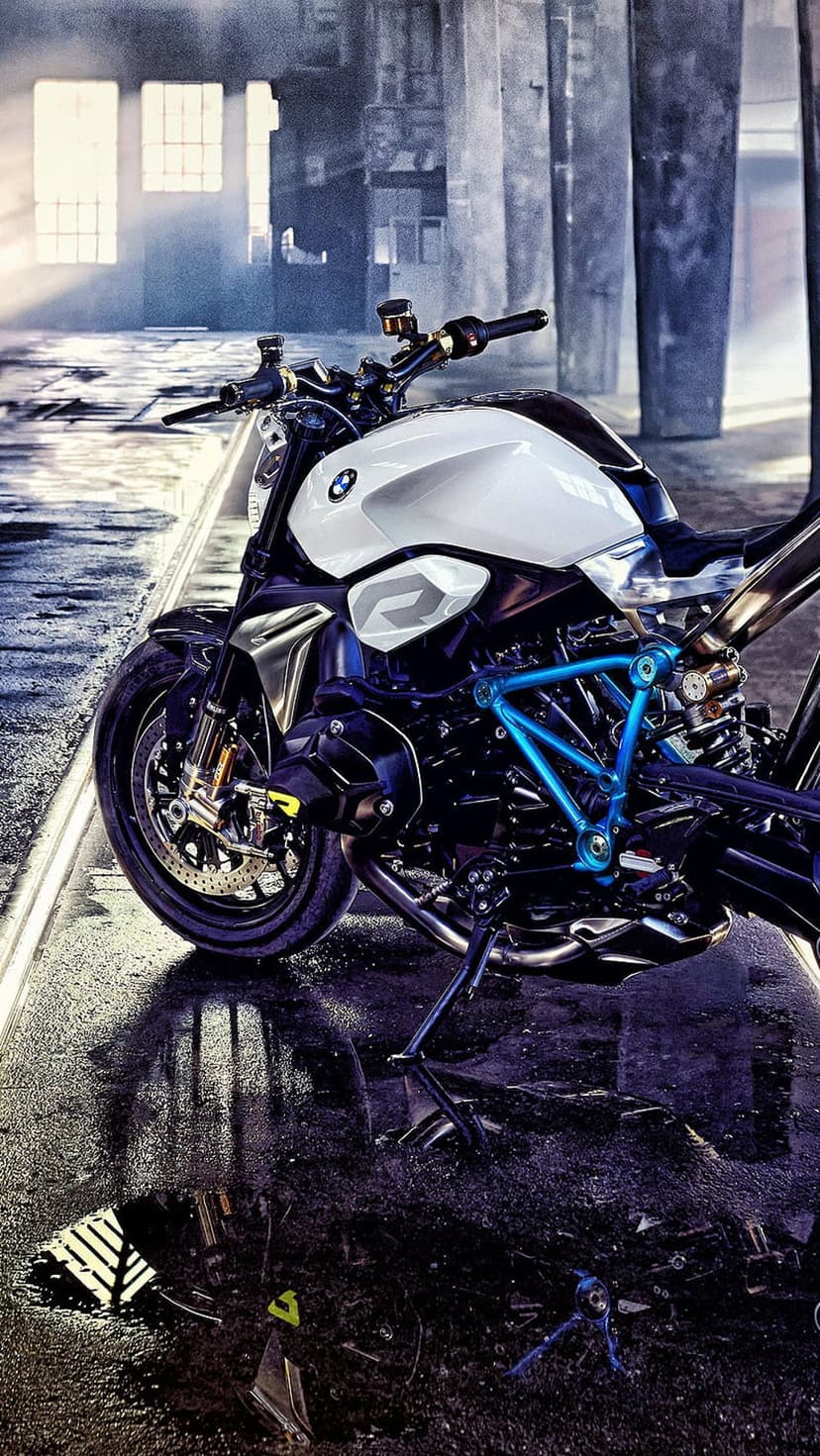 BMW sportbike with blue accents stands on a rain-slicked urban road beside puddles and industrial textures.