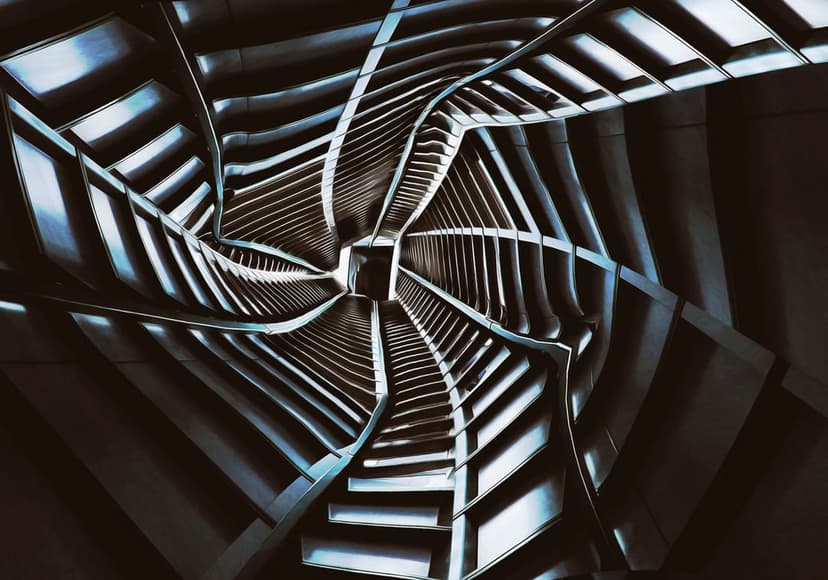 Metallic spiral staircase and glowing panels form a geometric tunnel leading toward a central light source.