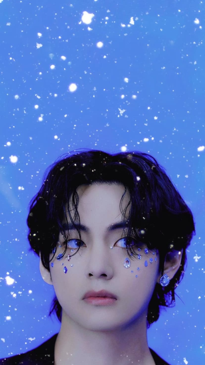 Kim Taehyung with blue eyes and shimmering face gems against a star-flecked blue background for phone screens.