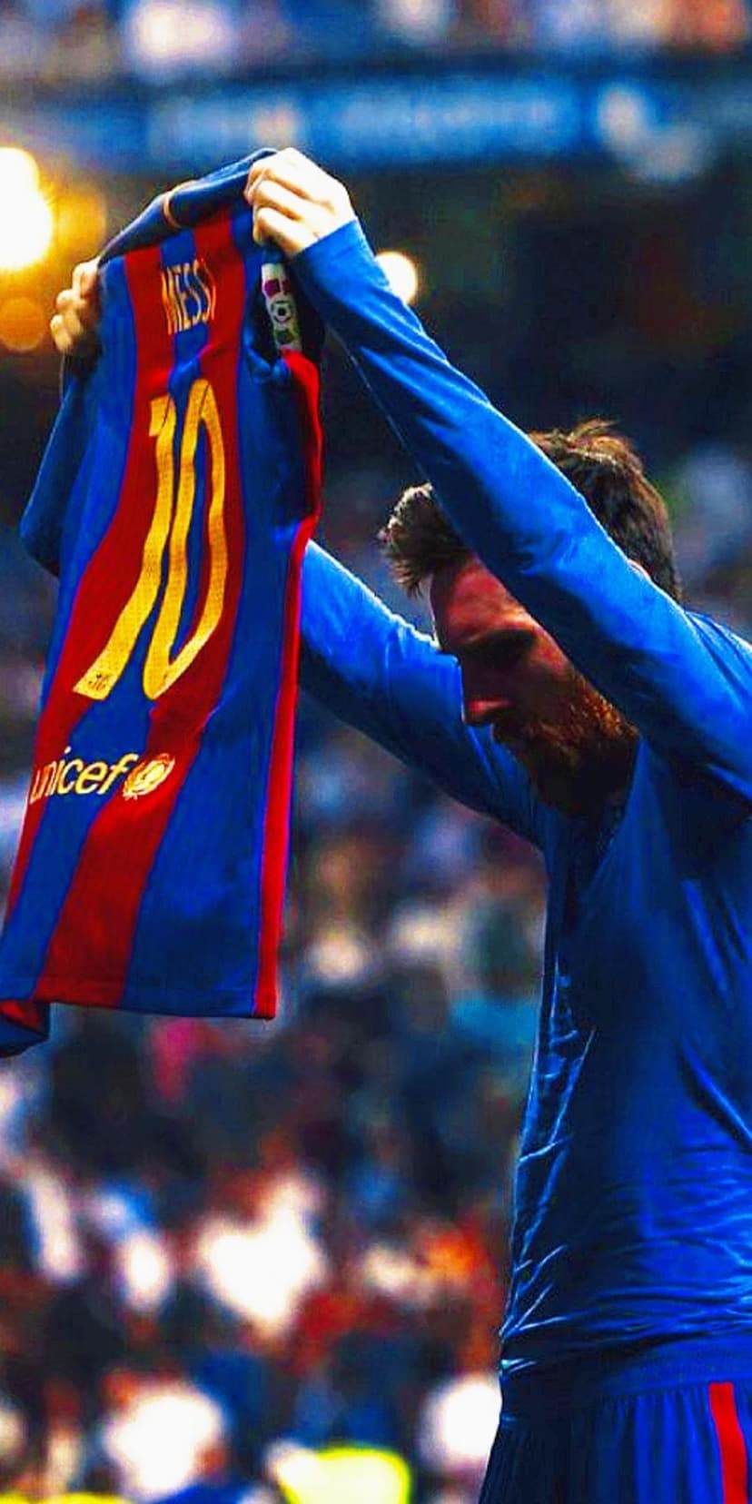 Lionel Messi holds a blue and red FC Barcelona jersey number ten while facing a blurred stadium crowd.