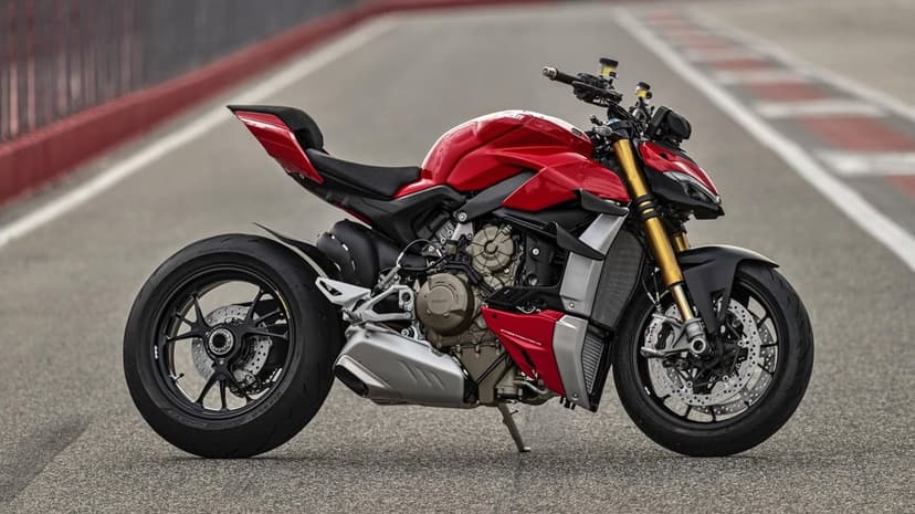 Red Ducati Streetfighter V4 S parked on an asphalt track with gold forks and silver engine details.