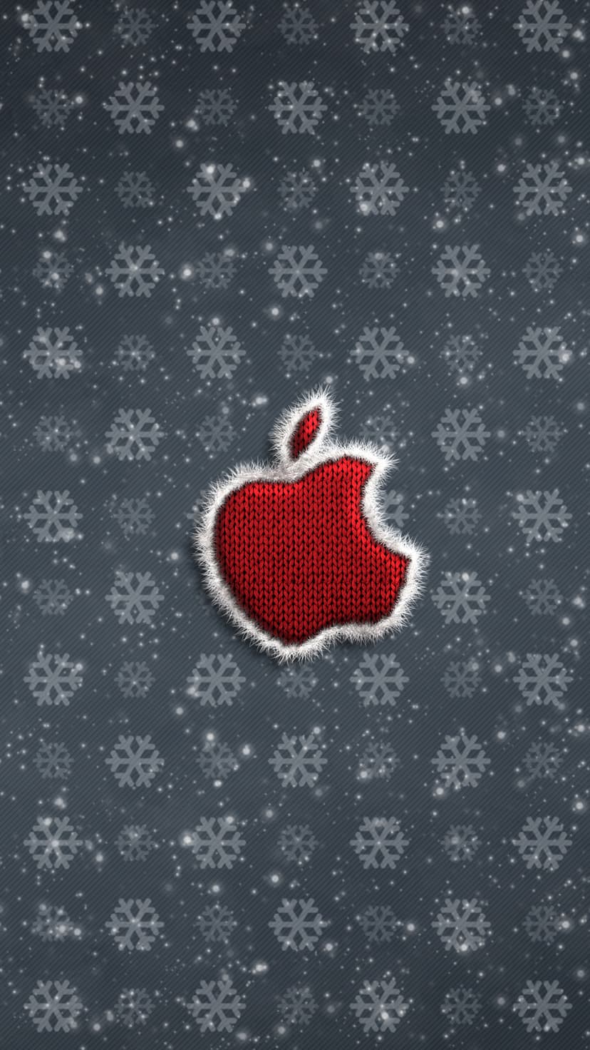 Red wool knitted Apple logo centered on a dark grey background with falling white snowflakes and snow.