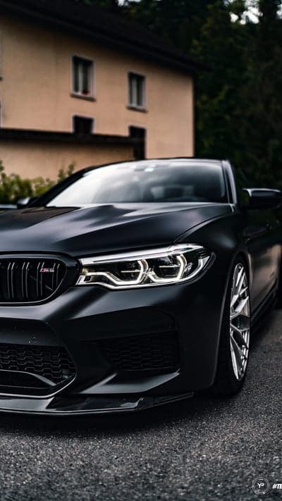Stealth BMW M5 Aggressive Front View Mobile Background