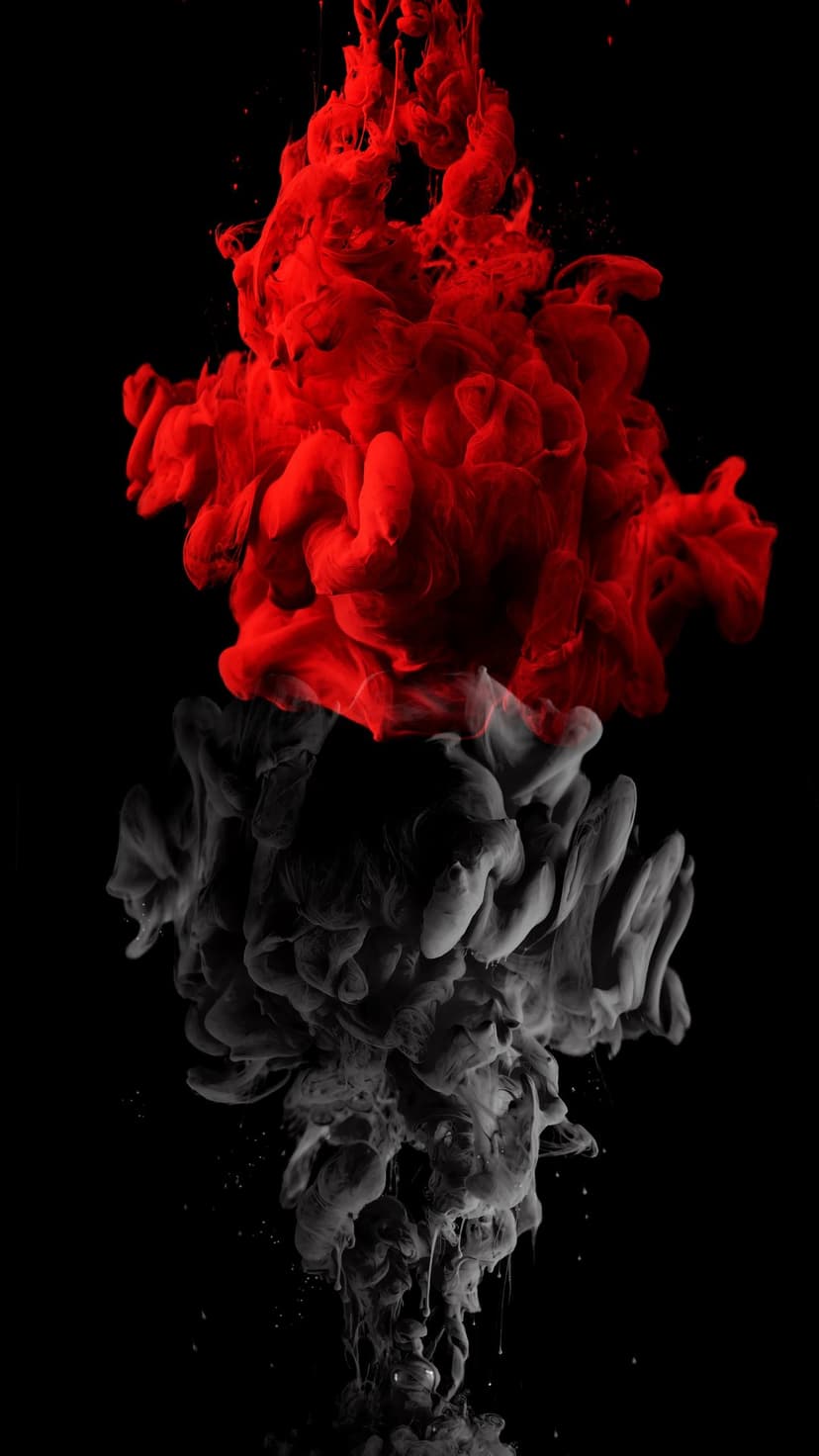 Crimson red ink plumes swirling and billowing upward against a stark black background in fluid motion.