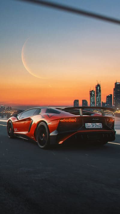 Red Lamborghini Aventador drives by city skyline at sunset