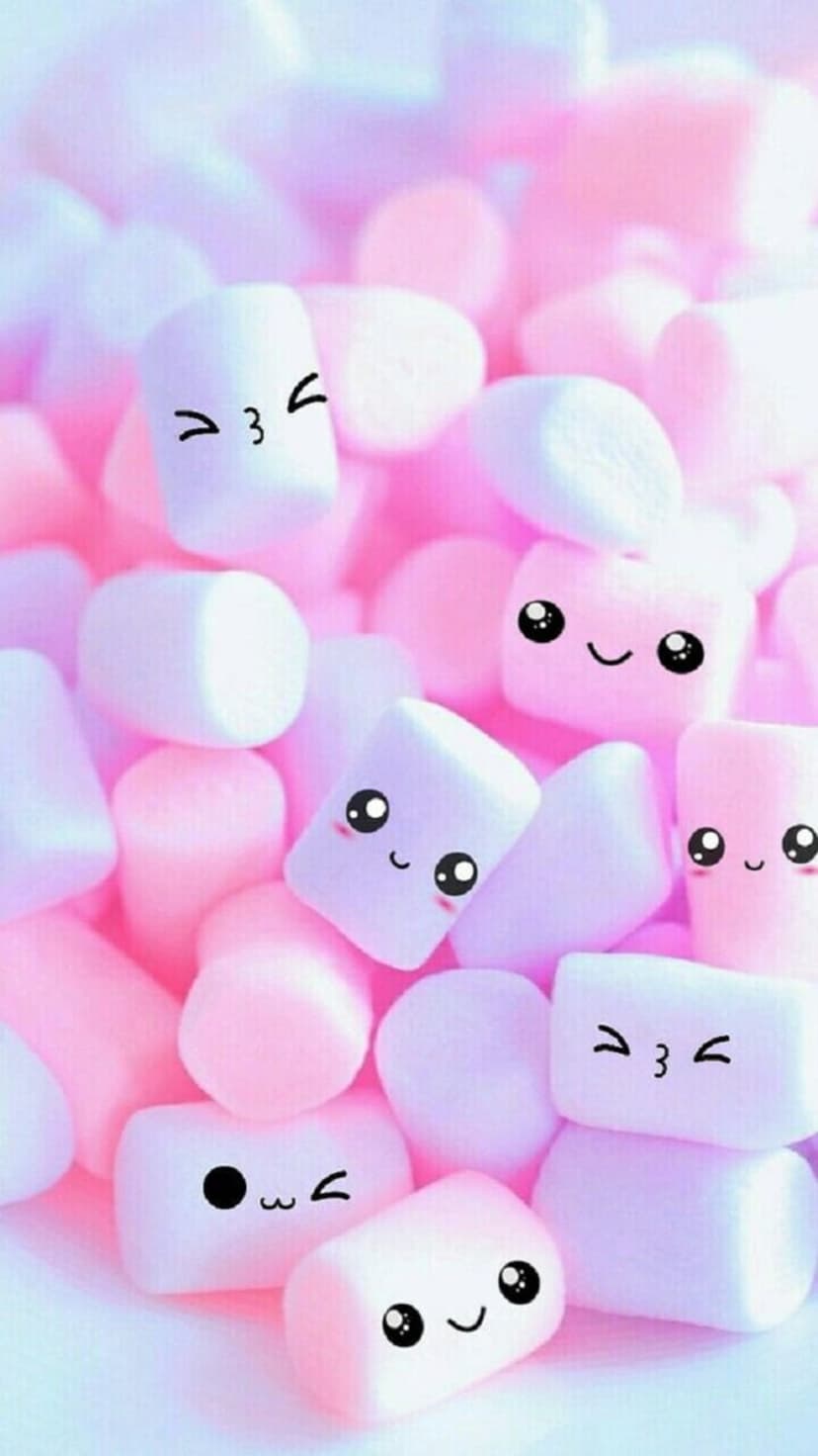 Marshmallows with tiny winking and smiling faces piled together in soft pastel shades of pink and lavender purple.