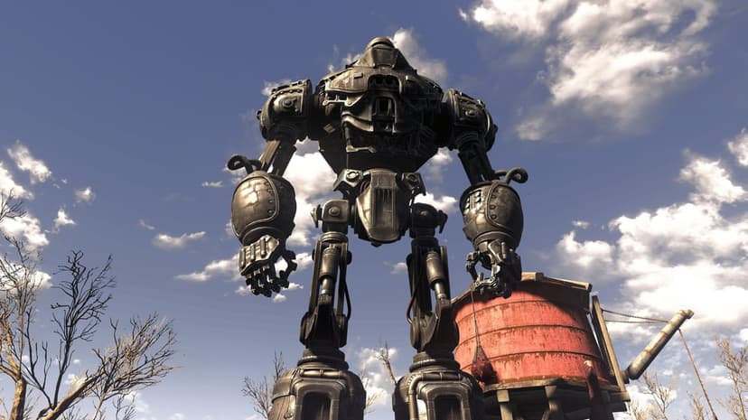 Giant iron robot stands over a wasteland landscape with a red water tower and blue cloudy sky in the background.