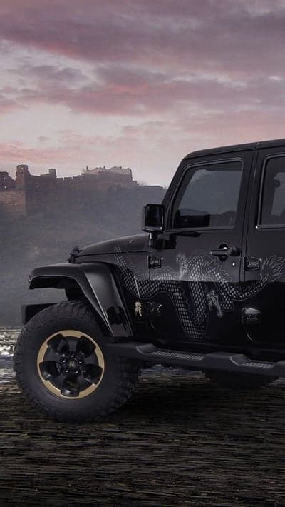 Dragon-themed black Jeep Wrangler with ancient castle background