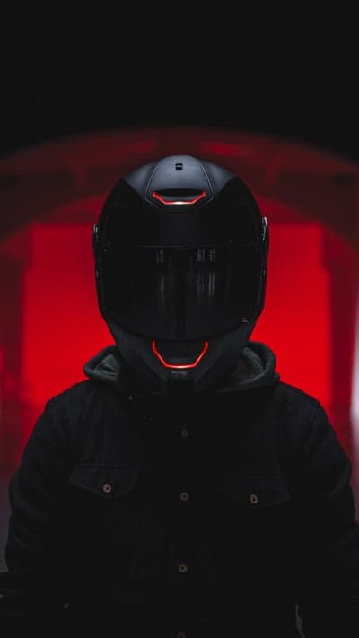 Person in Futuristic Motorcycle Helmet with Red Accents
