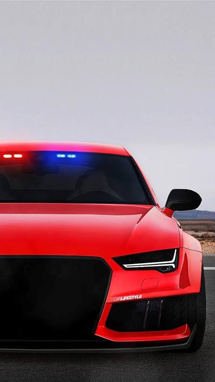 Red Audi sports car with flashing blue and red lights on the windshield, featuring a black grille and LED lamps.