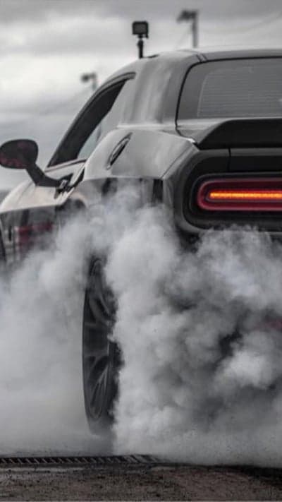 Muscle car doing a burnout in smoke