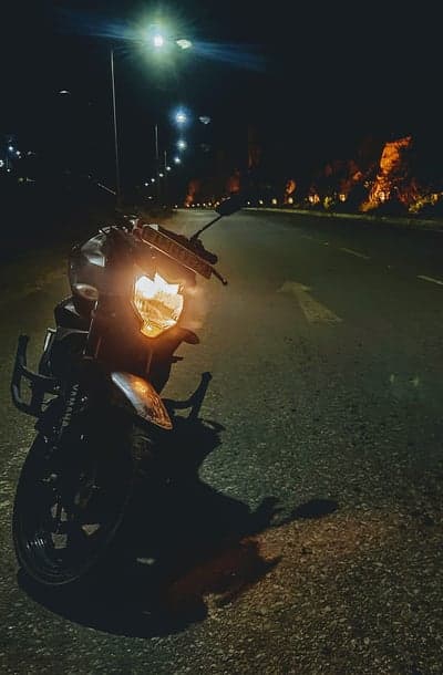 Night Motorcycle Ride on Empty Road with Streetlights