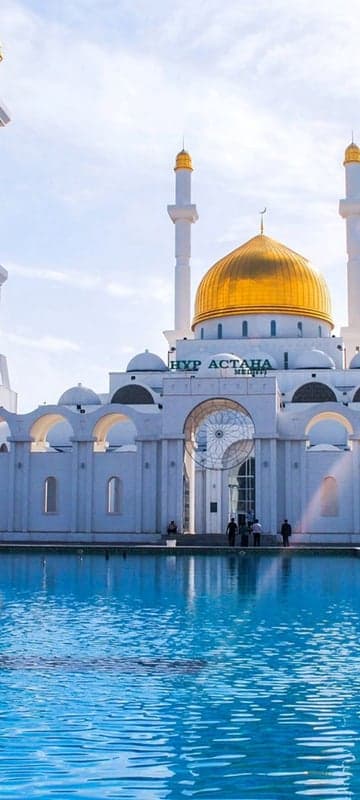Golden Dome Mosque Reflects in Blue Pool Under Sunny Sky