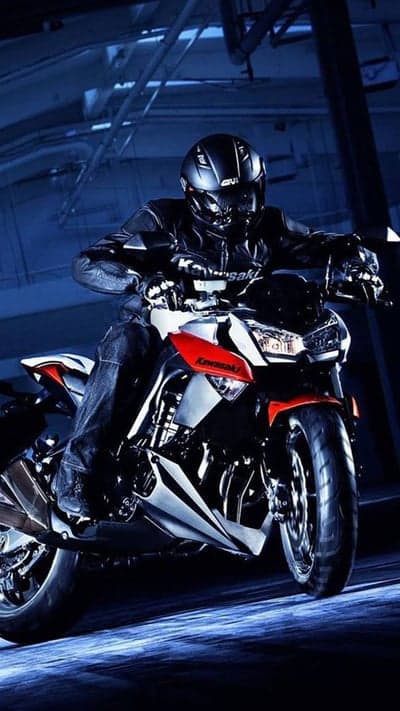 Motorcyclist in Black Gear on Kawasaki Motorcycle