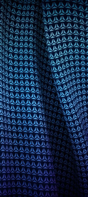 Dark blue fabric with a geometric triangular pattern
