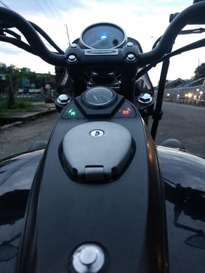 Motorcycle dashboard and handlebars at dusk