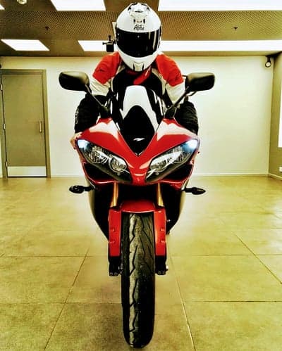 Motorcyclist in Red and White Gear on Sportbike