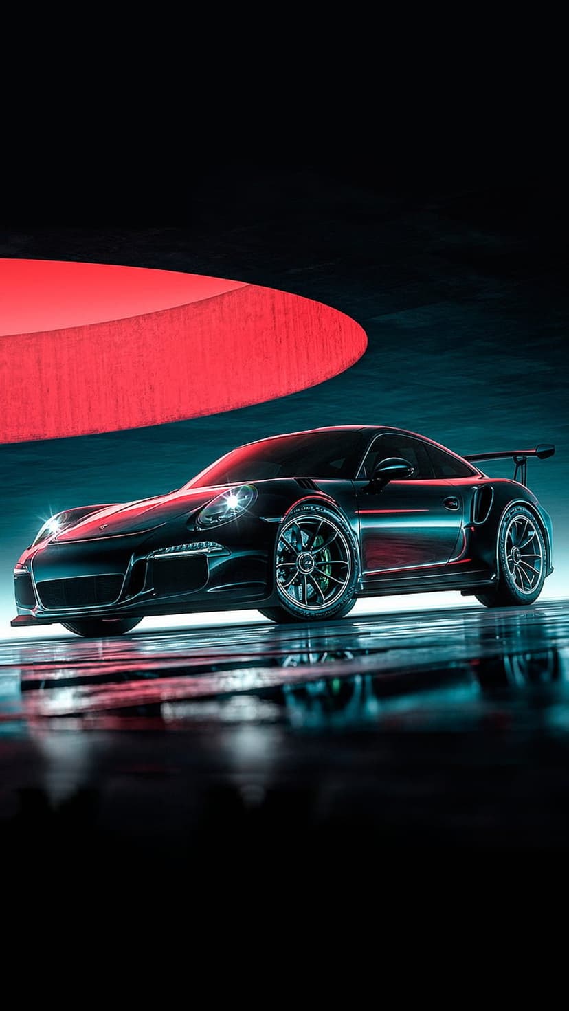 Porsche 911 GT3 RS in black sits on a wet surface with red neon lighting reflecting against the car and ground.