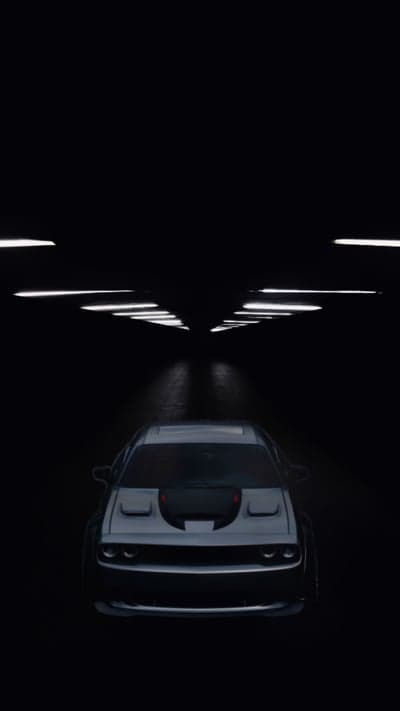 Dodge Challenger in a dark tunnel with lights