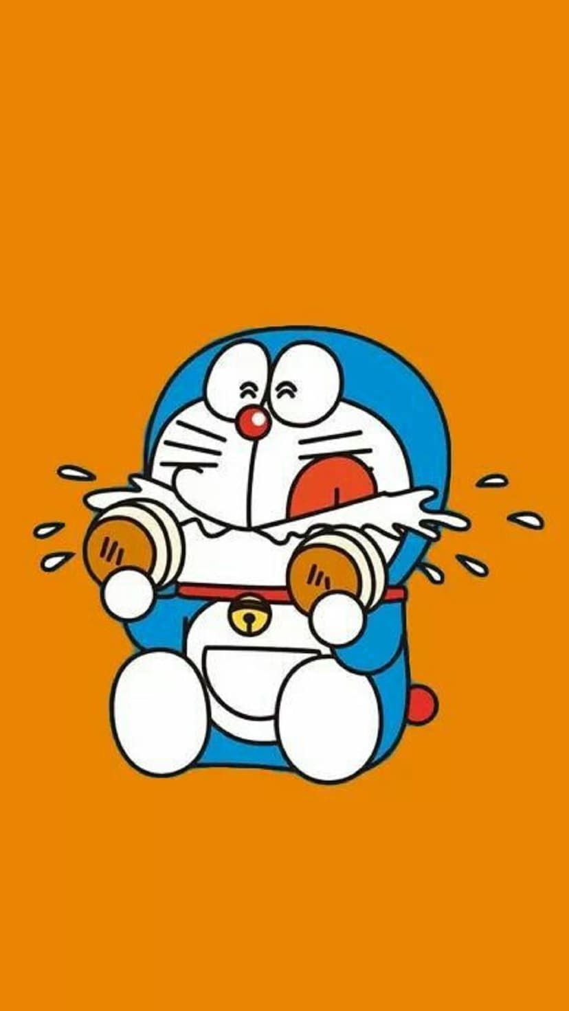 Doraemon cries with large tears while holding two brown pastries against a solid bright orange background.