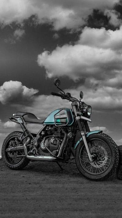 Custom Royal Enfield Himalayan motorcycle under dramatic sky
