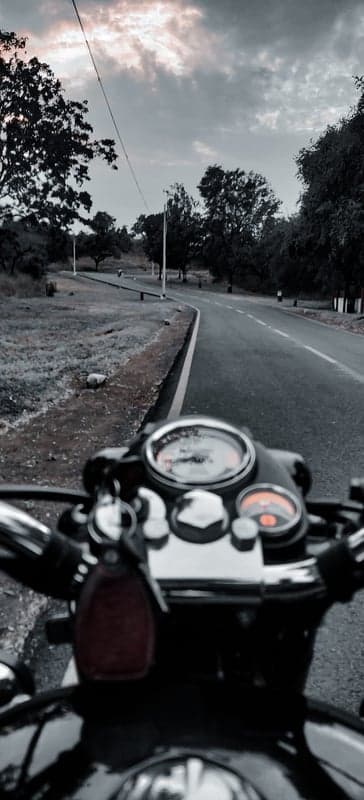 First-Person Biker View Under Stormy Sky Phone Background