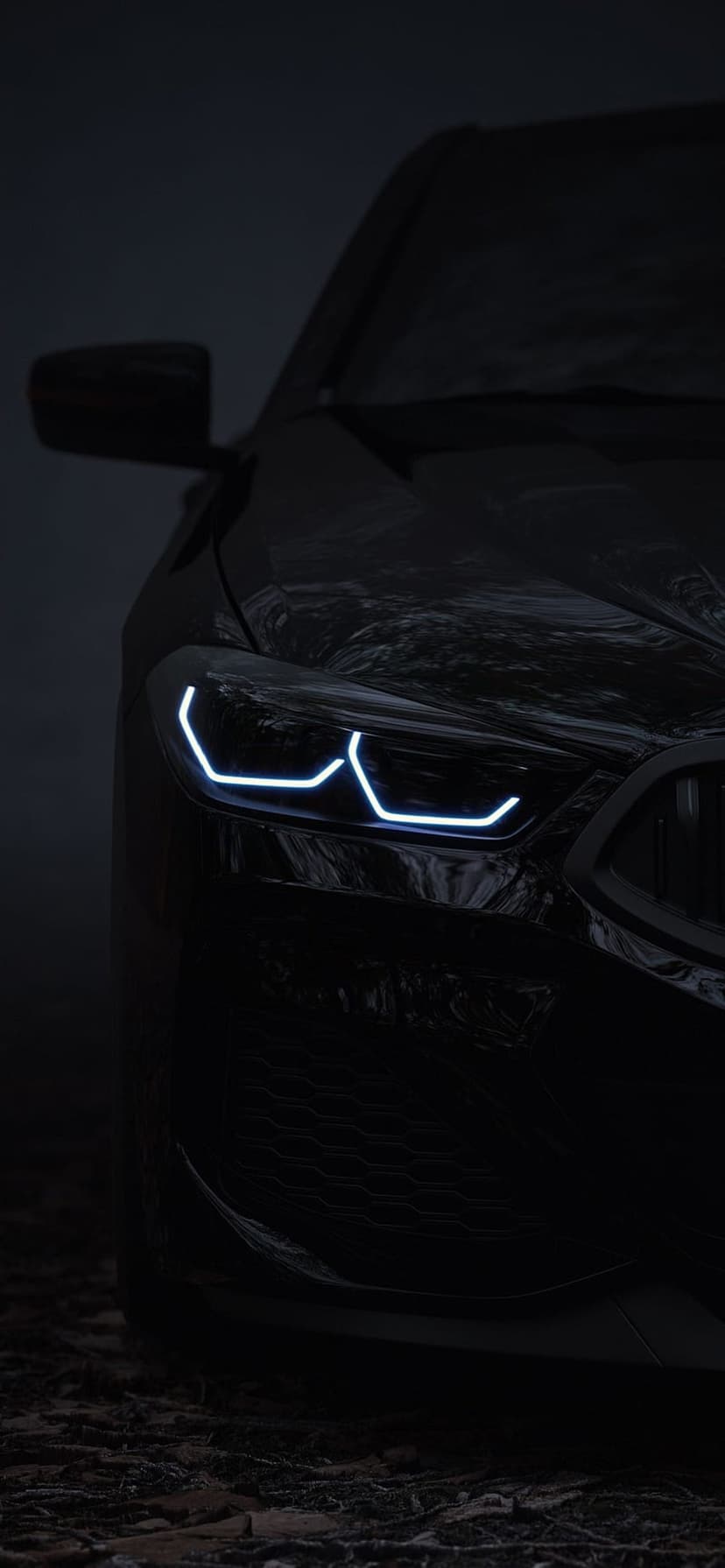 Modern car headlight with blue LED accents glows against a dark misty backdrop on a glossy black vehicle body.
