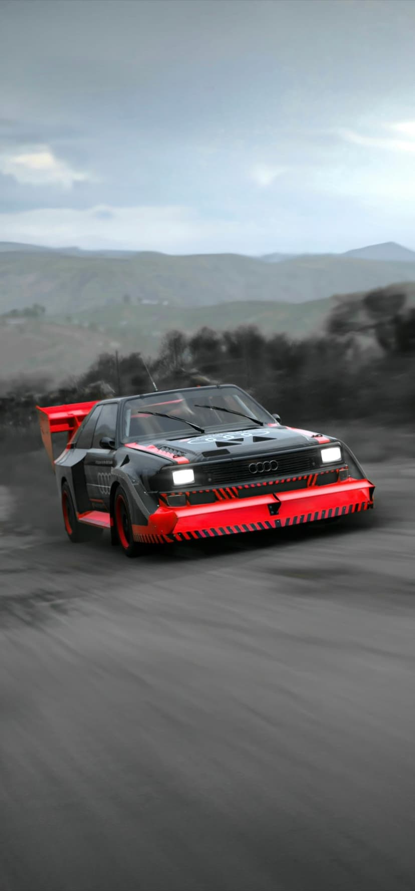 Audi Sport Quattro rally car in black and red livery drifts on a dirt track, kicking up a thick cloud of dust.