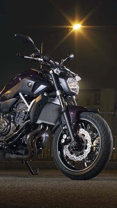 Nighttime Yamaha motorcycle under street lamp