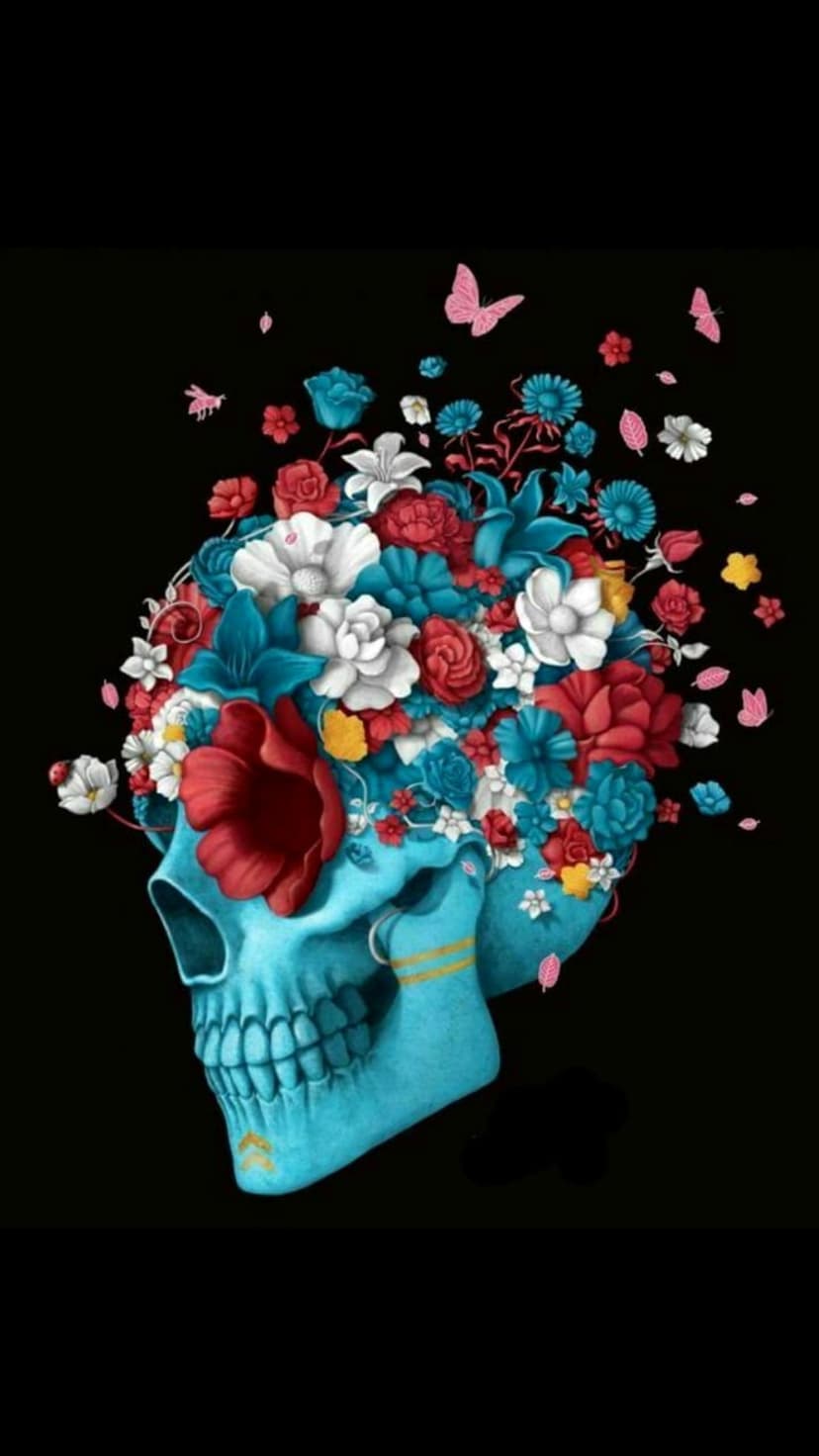 Blue skull decorated with red and white flowers and pink butterflies against a deep black background.