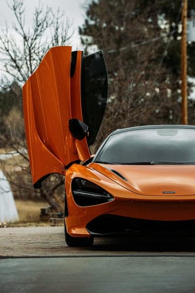 Orange McLaren 720S with dihedral doors open