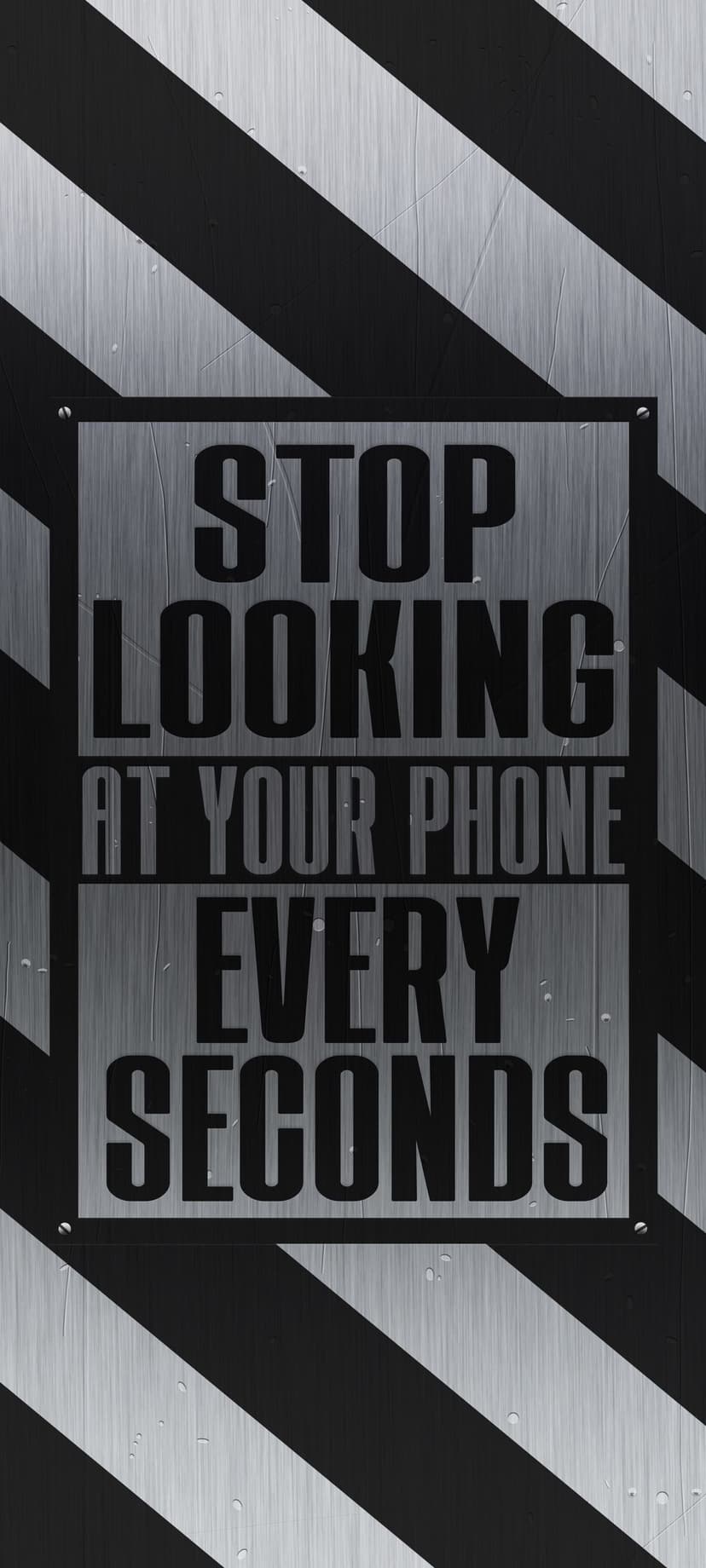 Metallic warning sign with black and white diagonal stripes reading stop looking at your phone every second.