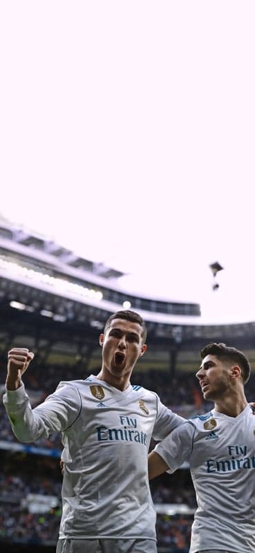 Cristiano Ronaldo celebrates a goal with teammate Asensio