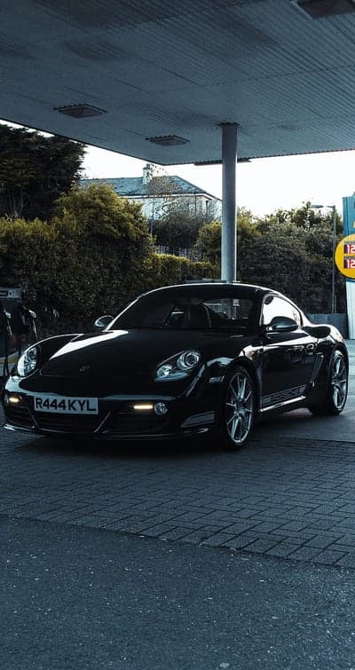 Black Porsche Cayman Night Gas Station Phone Wallpaper