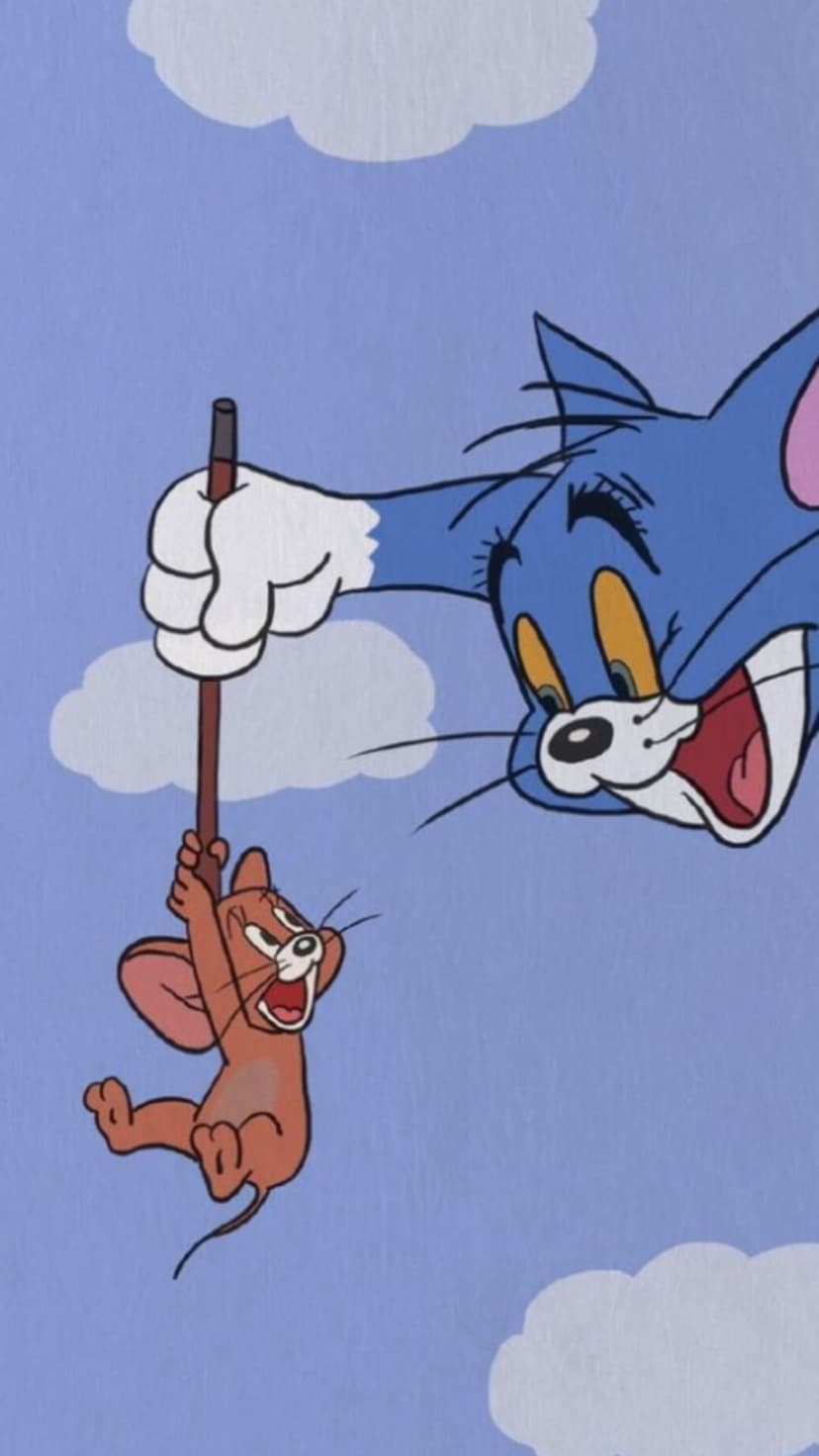 Tom cat grins while holding a terrified Jerry mouse on a wooden pole against a clear blue sky with white clouds.
