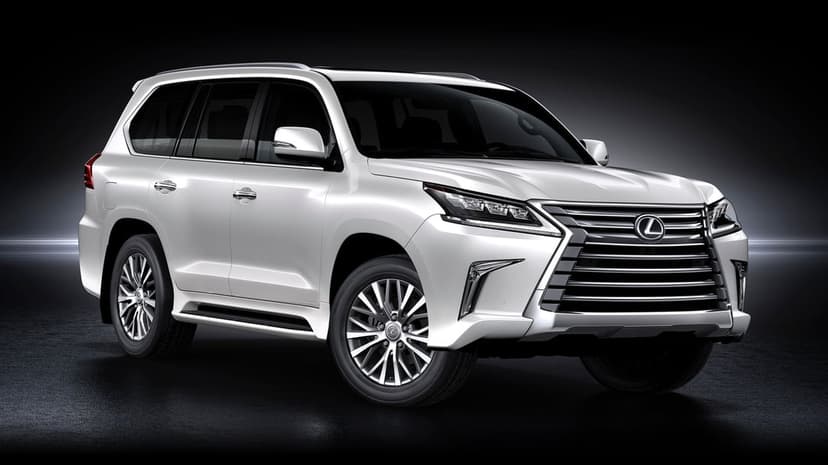 A front three-quarter view of a white Lexus LX luxury SUV with chrome accents against a dark studio floor.