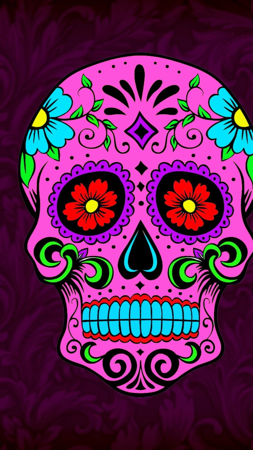 Pink sugar skull with blue and red floral patterns on the forehead and eyes against a vibrant background.