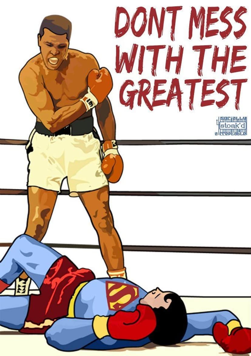 Muhammad Ali stands over a fallen Superman wearing a red cape and blue suit inside a boxing ring with three ropes.