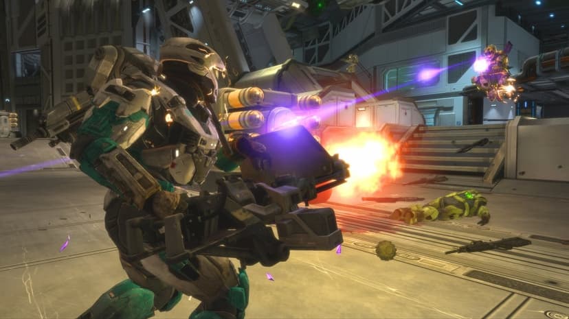 Spartan soldier firing a machine gun turret amidst purple plasma bolts in a gritty industrial hangar battle.