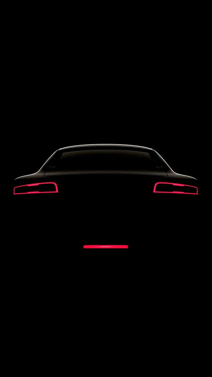 Sleek supercar silhouette featuring glowing red LED taillights and a thin light bar against a black background.