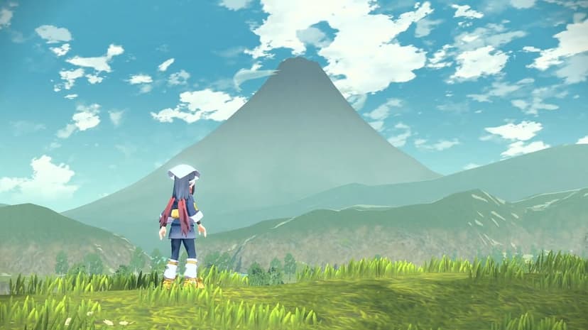 Character in survey corps gear overlooks a vast green valley and a massive mountain peak under a clear blue sky.