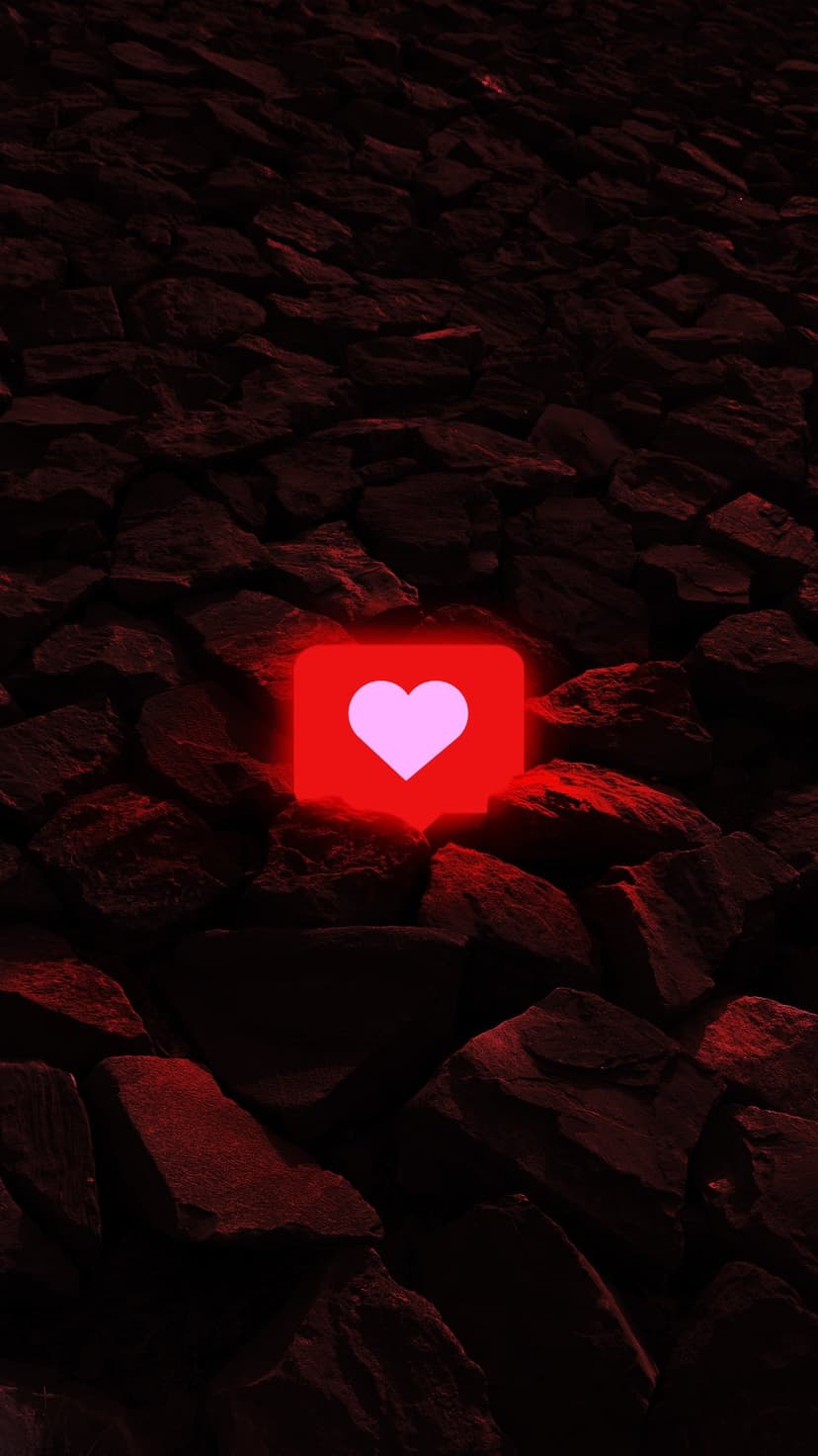 Luminous pink heart icon in a rounded red square set against a backdrop of dark, textured volcanic rocks.