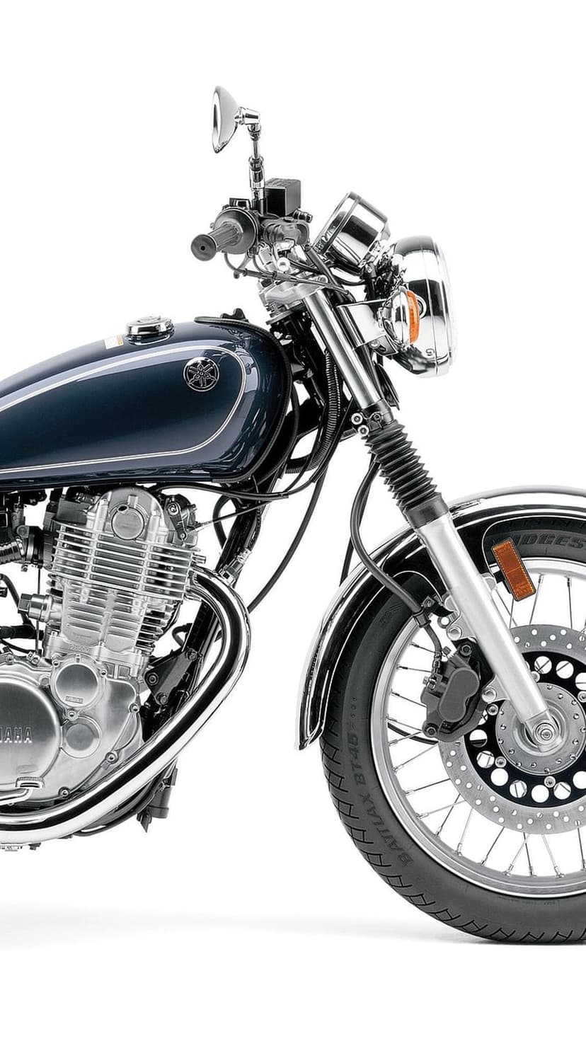 Yamaha motorcycle engine with chrome details and spoked front wheel positioned against a white studio background.
