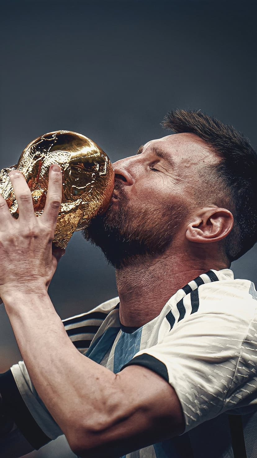 Lionel Messi kisses the gold World Cup trophy while wearing the blue and white striped Argentina national jersey.