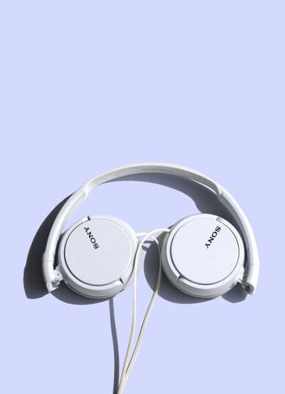 White Sony Headphones on Light Purple Background