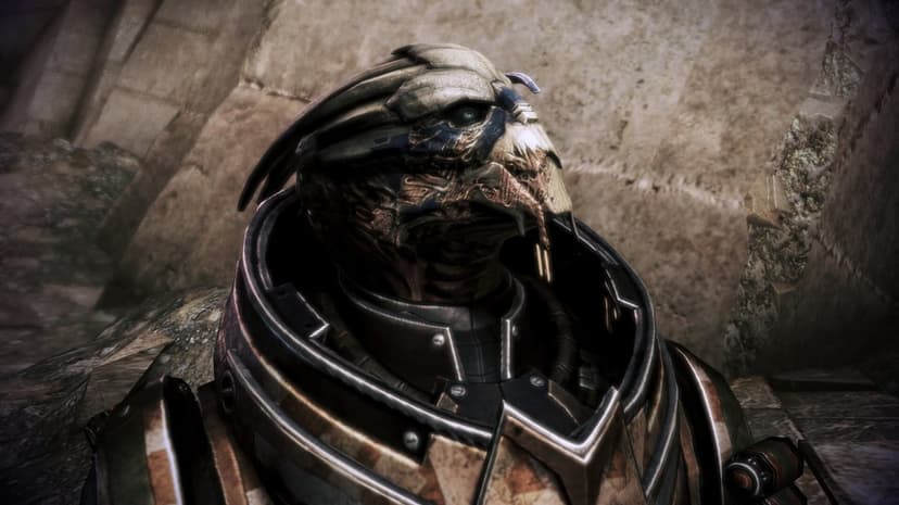 Close-up profile of a scarred alien turian soldier in heavy armor against a blurred desert backdrop.