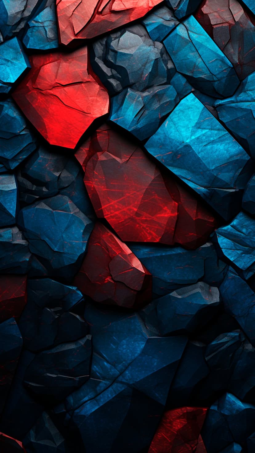 Red and blue angular crystals with sharp facets and dramatic highlights creating deep shadows across the surface.